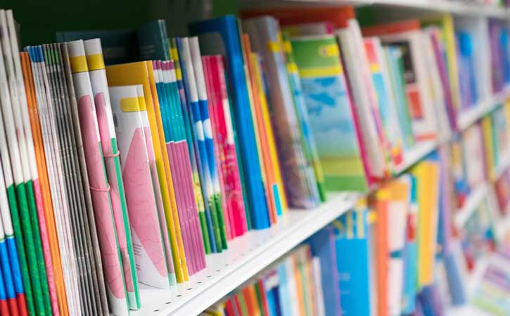 full shelves of a variety of multi-coloured books