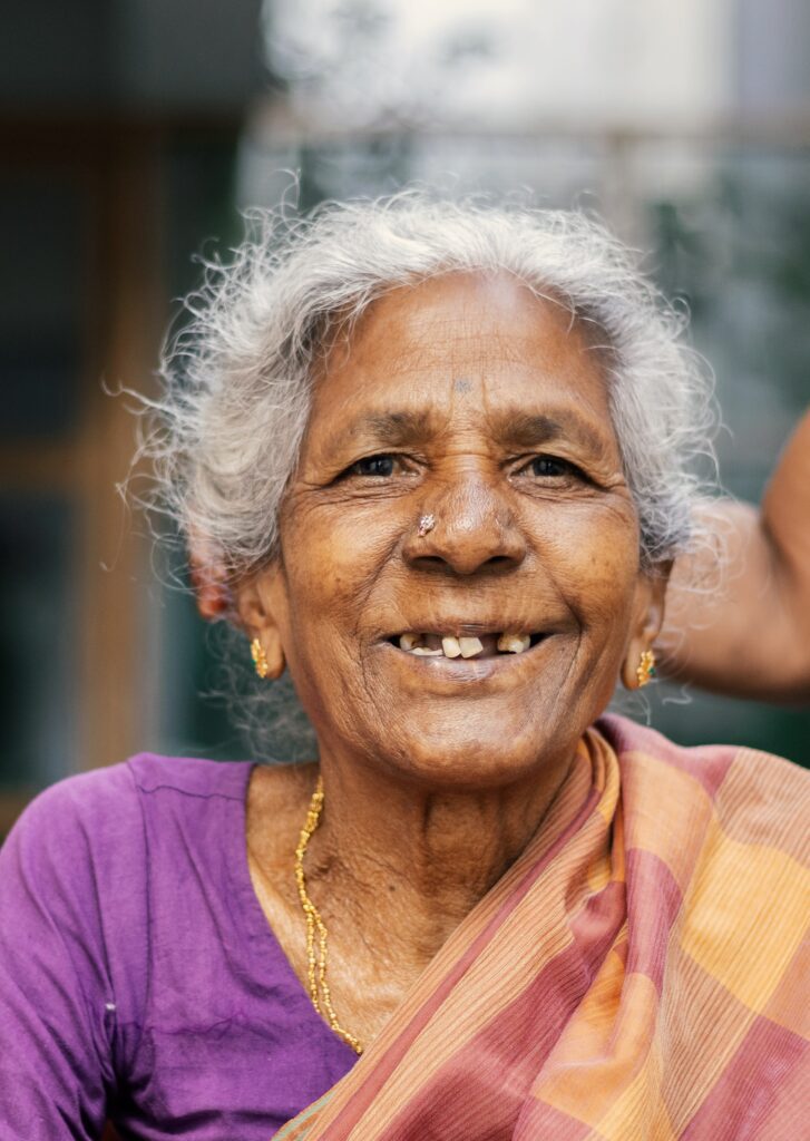 elderly brown woman smiling with healthy mental wellbeing