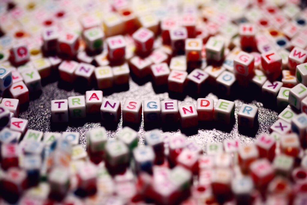 letter blocks spelling out transgender in the middle of many colour blocks